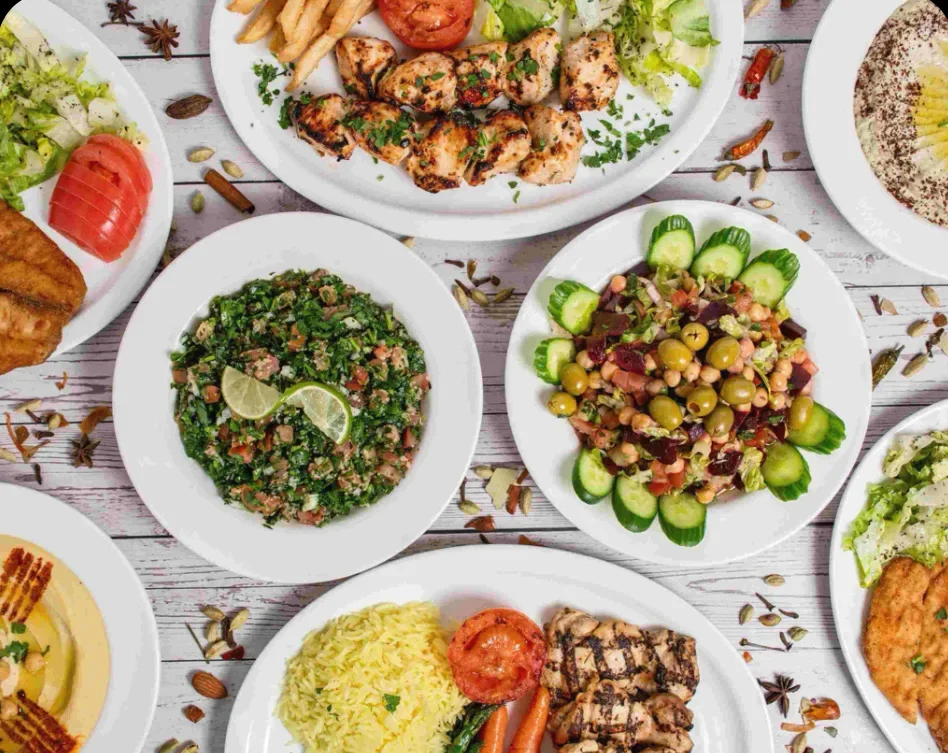 A colourful spread of Middle Eastern salads, grilled chicken and dips